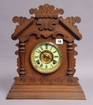 A late 19th century American Gingerbread mantel clock by the Ansonia Clock Co., having black roman