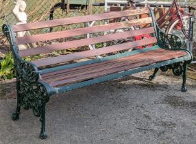 A Victorian-style garden bench with green painted cast-iron pierced & foliate design end supports, &