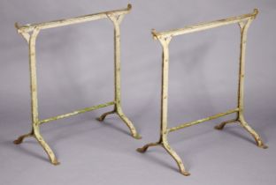 A pair of vintage white painted cast-iron trestle table supports, 74.5cm wide x 75cm high.