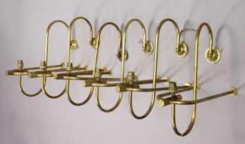 A set of six brass wall-mounted wall sconces, 43cm wide x 43cm high