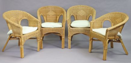 A set of four wicker tub-shaped chairs.