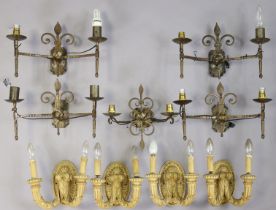 Nine various twin-branch wall sconces.