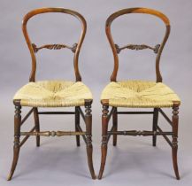 A pair of Victorian rosewood occasional chairs, each with open hooped spindle back and rush seat, on