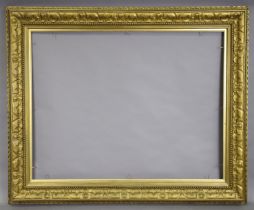 A 19th century gilt-gesso large picture frame with a raised scroll border & with a beaded edge (