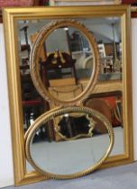 A large gilt frame oval wall mirror inset with a bevelled plate, _ cm x _cm; & two gilt frame oval