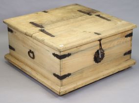 An Eastern-style iron-bound large square wooden storage trunk with a double hinged lift-lid, iron