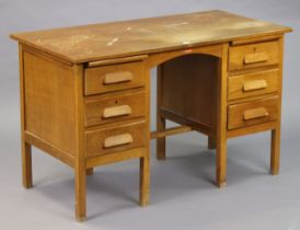 A mid-20th century oak knee-hole desk fitted three long drawers to either side, & on short square