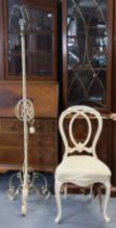 A Victorian white painted & carved wooden balloon-back salon chair with a padded seat, & on