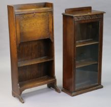 An Edwardian oak desk/bookcase with a fitted interior enclosed by a fall-front above two open