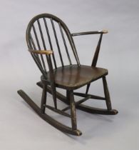 An Ercol spindle-back rocking chair with a hard seat, & on round tapered supports with spindle
