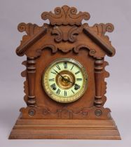 A late 19th century American Gingerbread mantel clock by the Ansonia Clock Co., having black roman