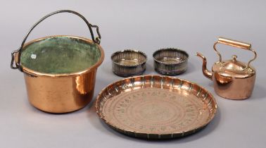 A copper engraved circular tray, 41cm diameter; a copper preserve pan, 30cm diameter; a copper