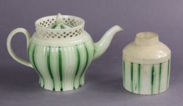 An 18th century English creamware fluted baluster teapot with tall pierced rim & running green