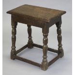 A 17th century oak joint stool, the rectangular two-board top with moulded edge, on turned