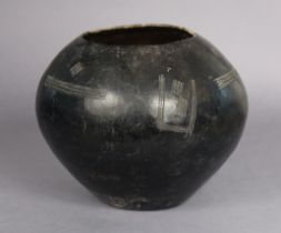 A South African Zulu ceremonial clay beer pot or Ukhamba with incised decoration, 23cm high.