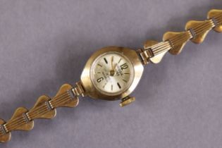 An Oriosa 9ct gold ladies’ bracelet watch, the small circular silvered dial with gold baton numerals