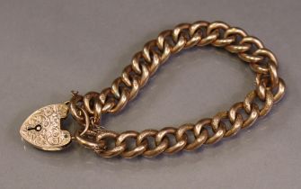 A 9ct gold flexible bracelet of engraved hollow curb links, with engraved padlock clasp & safety