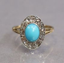 An early 20th century 18ct. gold & platinum ring set oval turquoise cabochon within a border of rose