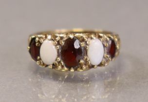 A 9ct gold ring set three oval garnets & two opals, size O (3.2g).