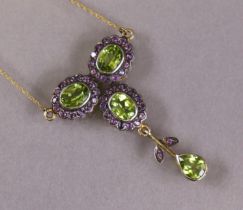 A peridot trefoil-shaped pendant, the three oval-cut stones set within borders of small amethysts, a