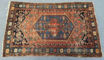 An antique Heriz rug, 200cm x 130cm (extensive wear).