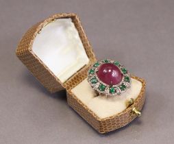 A ruby, emerald & diamond ring, the large oval cabochon ruby weighing approx. 22.3 carats, set