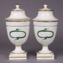 A pair of late 18th/early 19th century continental porcelain ovoid vases & covers, each painted in