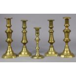 An 18th century brass candlestick, 20cm high; & two pairs of Victorian candlesticks, 26.5cm & 24.5cm