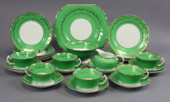 A porcelain twenty-seven piece part tea service of green and white ground with gilt