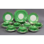 A porcelain twenty-seven piece part tea service of green and white ground with gilt