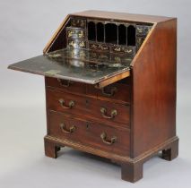 An 18th century mahogany bureau with Chinoiserie-lacquered fitted interior enclosed by a sloping