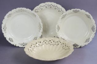 A matched pair of late 18th century English creamware plates, the pierced borders with moulded