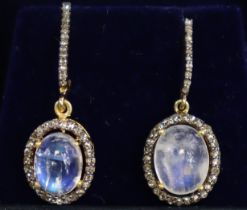 A pair of moonstone drop earrings, the oval cabochon stones set within narrow borders of small