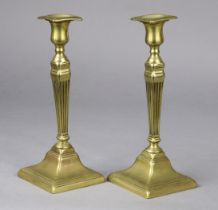 A pair of George III brass candlesticks of square tapered form, 26cm high (one with solder repair).