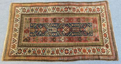 A Caucasian rug, the striped ground of contrasting colours, with all-over repeating geometric