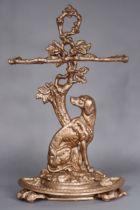 A Victorian cast-iron two-division umbrella stand in the form of entwined branches with seated dog