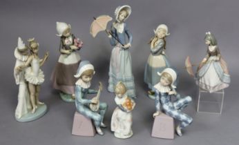 A collection of eight various Lladro porcelain figures, including a dancing Pierrot group (some box