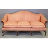 A Victorian Chippendale-style mahogany frame camel-back sofa with carved decoration, upholstered