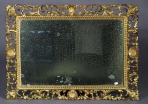 A late 19th century Florentine wall mirror in carved & pierced giltwood frame, inset plain mirror