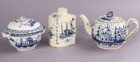 An 18th century English creamware round teapot painted in blue with a continuous landscape, with