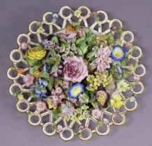 A 19th century porcelain centrepiece in the form of a display of mixed flowers in a circular dish