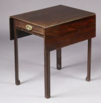 A George III mahogany Pembroke table with rectangular drop-leaves, fitted frieze drawer to each