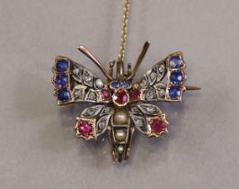 A late Victorian butterfly brooch set rose diamonds, sapphires, rubies, & split-pearls, to un-marked