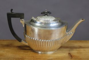 A George V silver oval semi-fluted teapot; Birmingham 1913, by Alexander Clark & Co. (16oz).