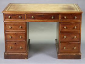 A Victorian mahogany pedestal desk with tooled tan leather top, fitted nine drawers with brass