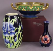 A Moorcroft pottery ovoid vase with tall narrow neck, decorated with anemonies on a deep blue ground