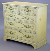 A Regency-style cream-painted chest of drawers with ribbon and husk-swag decoration, fitted two