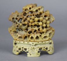 A Chinese soapstone carving of a fruit tree with animals amongst the pierced foliage, 13cm high.