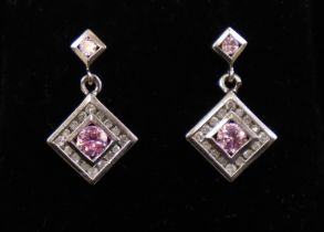 A pair of 9ct white gold lozenge-shaped drop earrings, each set round-cut pink sapphire within a