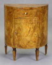 A continental burr walnut demi-lune side cabinet, fitted with a frieze drawer above a small cupboard